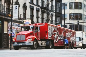 Budweiser truck unloading on a busy Chicago street, highlighting urban transportation and commerce.